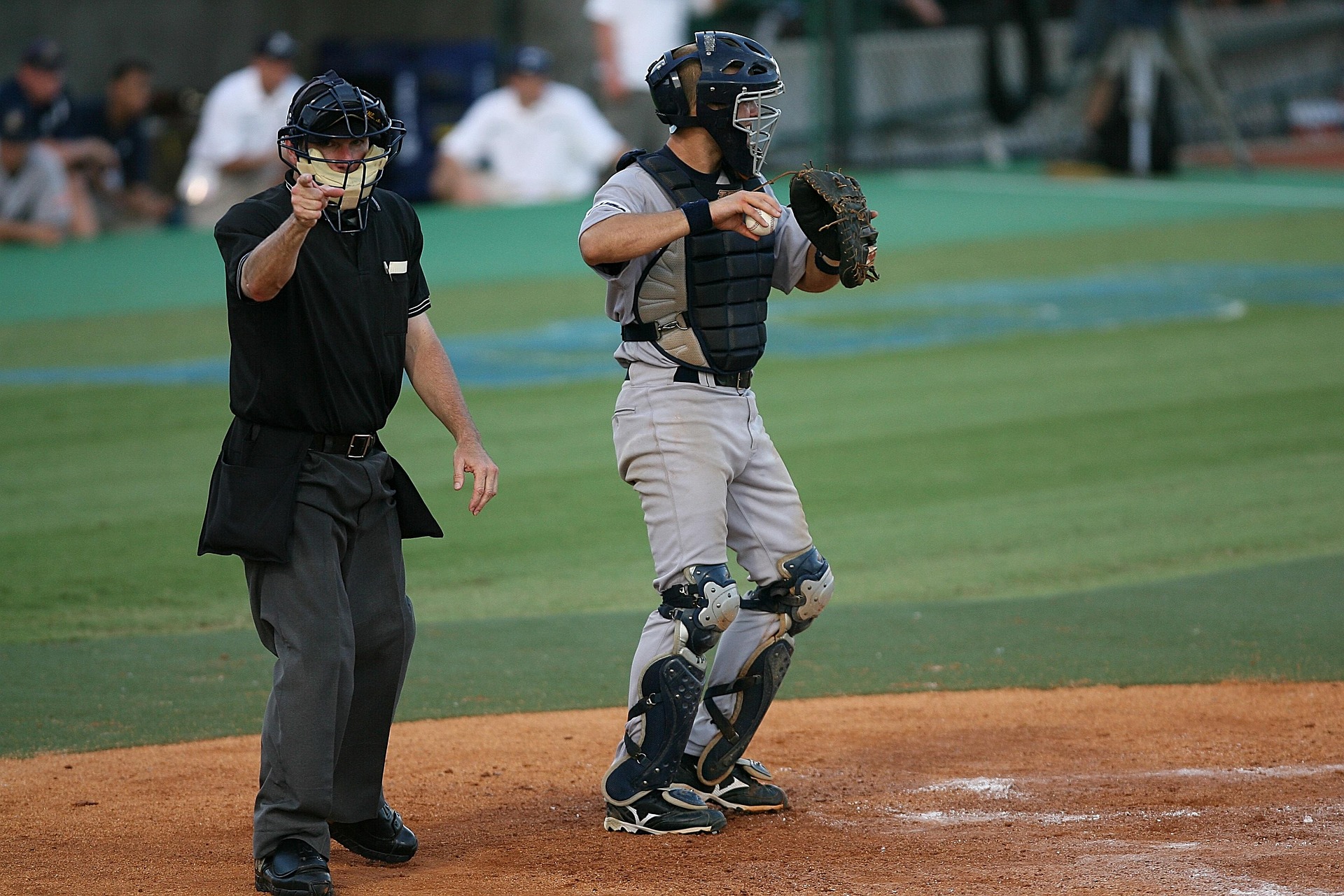 Home plate umpire signaling a ball-strike call during a baseball game.
