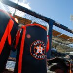 Houston Astros spring training equipment bags near the dugout at CACTI Park.