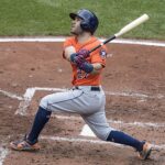 Jose Altuve of Venezuela swings a baseball bat at home plate.