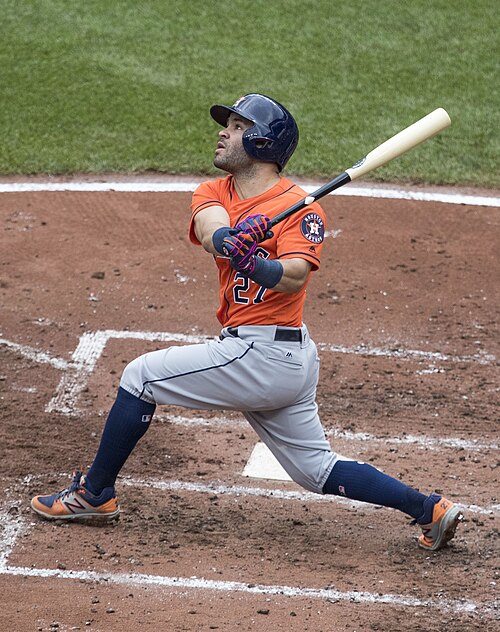 Jose Altuve of Venezuela swings a baseball bat at home plate.