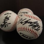 Autographed baseballs in a cluster.