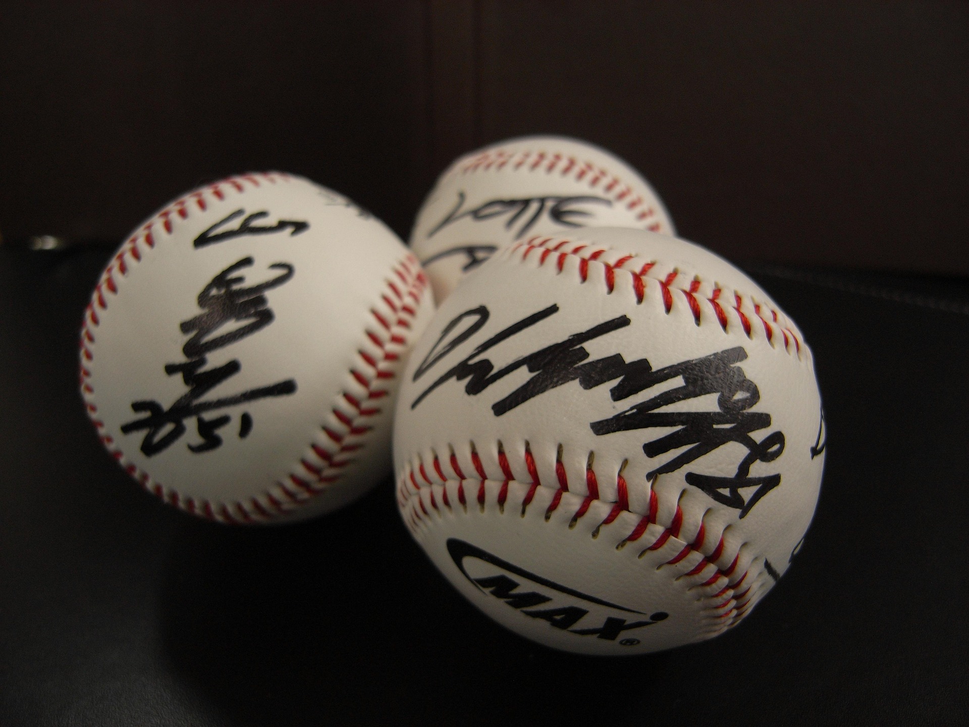 Autographed baseballs in a cluster.