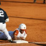 A baseball player gets tagged out sliding into base.