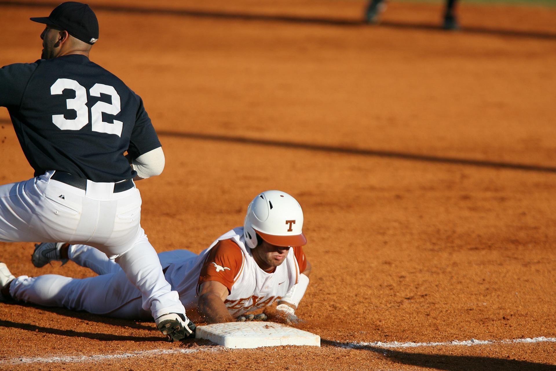 A baseball player gets tagged out sliding into base.