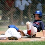 Two baseball players collide at base.