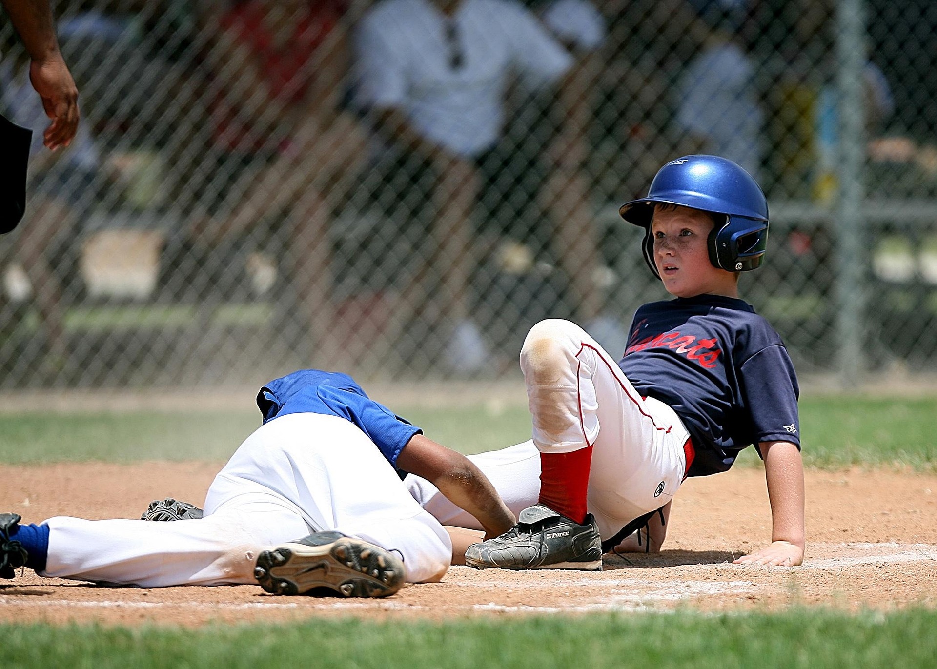 Two baseball players collide at base.
