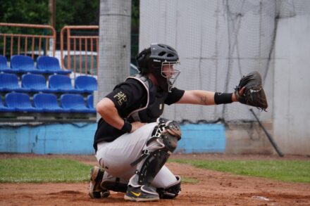 A baseball catcher is ready for the next pitch.