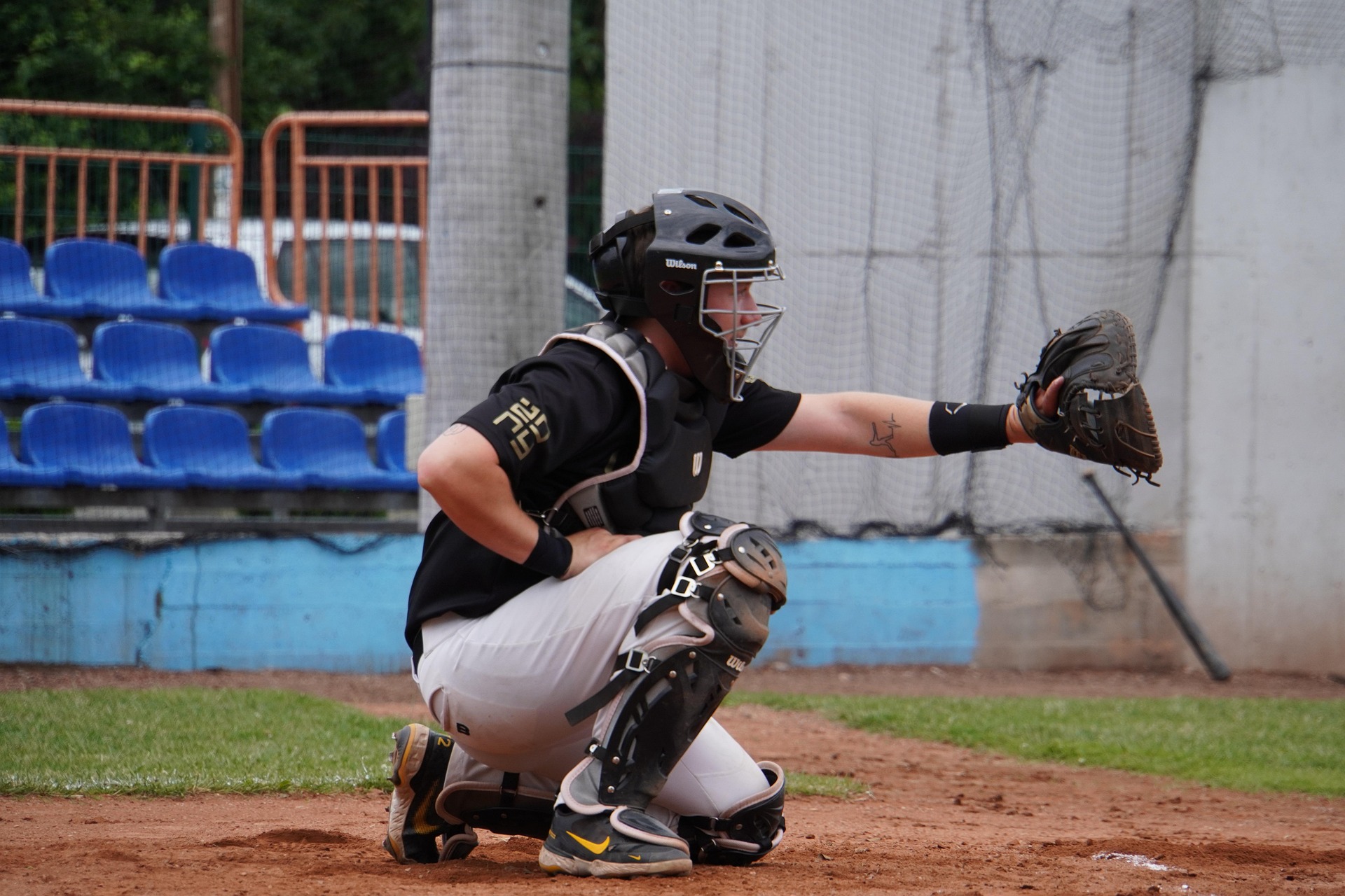 A baseball catcher is ready for the next pitch.