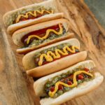 Variety of hot dogs at a baseball game.