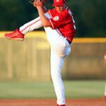 A baseball pitcher delivering a pitch during a game.