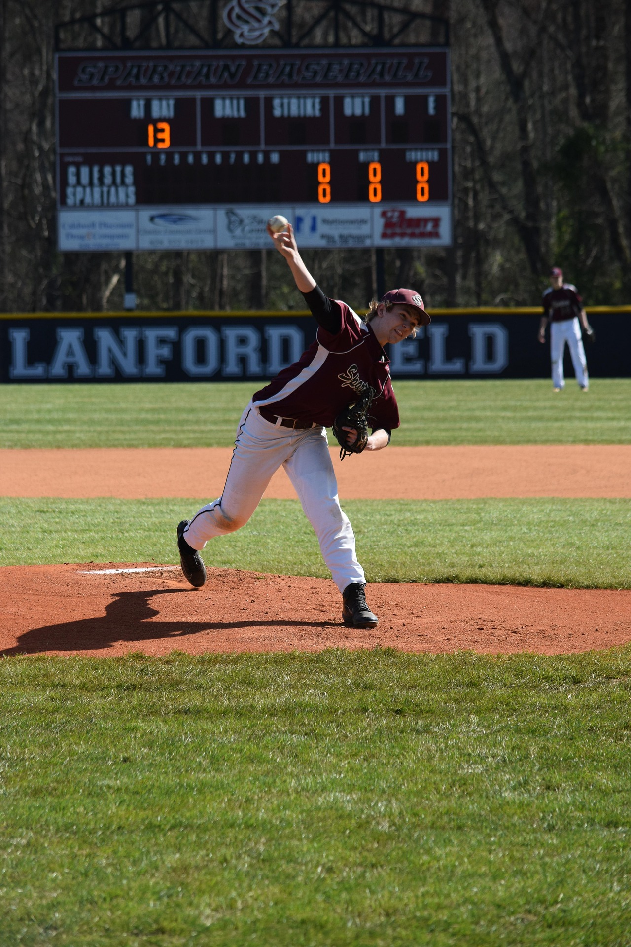 A pitcher throws a baseball toward the box.
