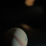 Baseball in low light, half in shadow, symbolizing Astros injury struggles