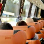 People on a bus ride to a baseball game.
