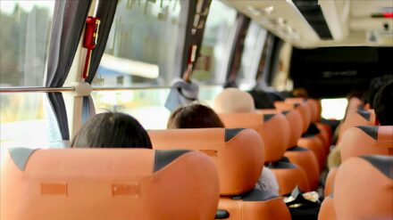 People on a bus ride to a baseball game.