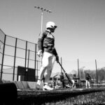 A baseball player at home plate, awaiting a pitch.