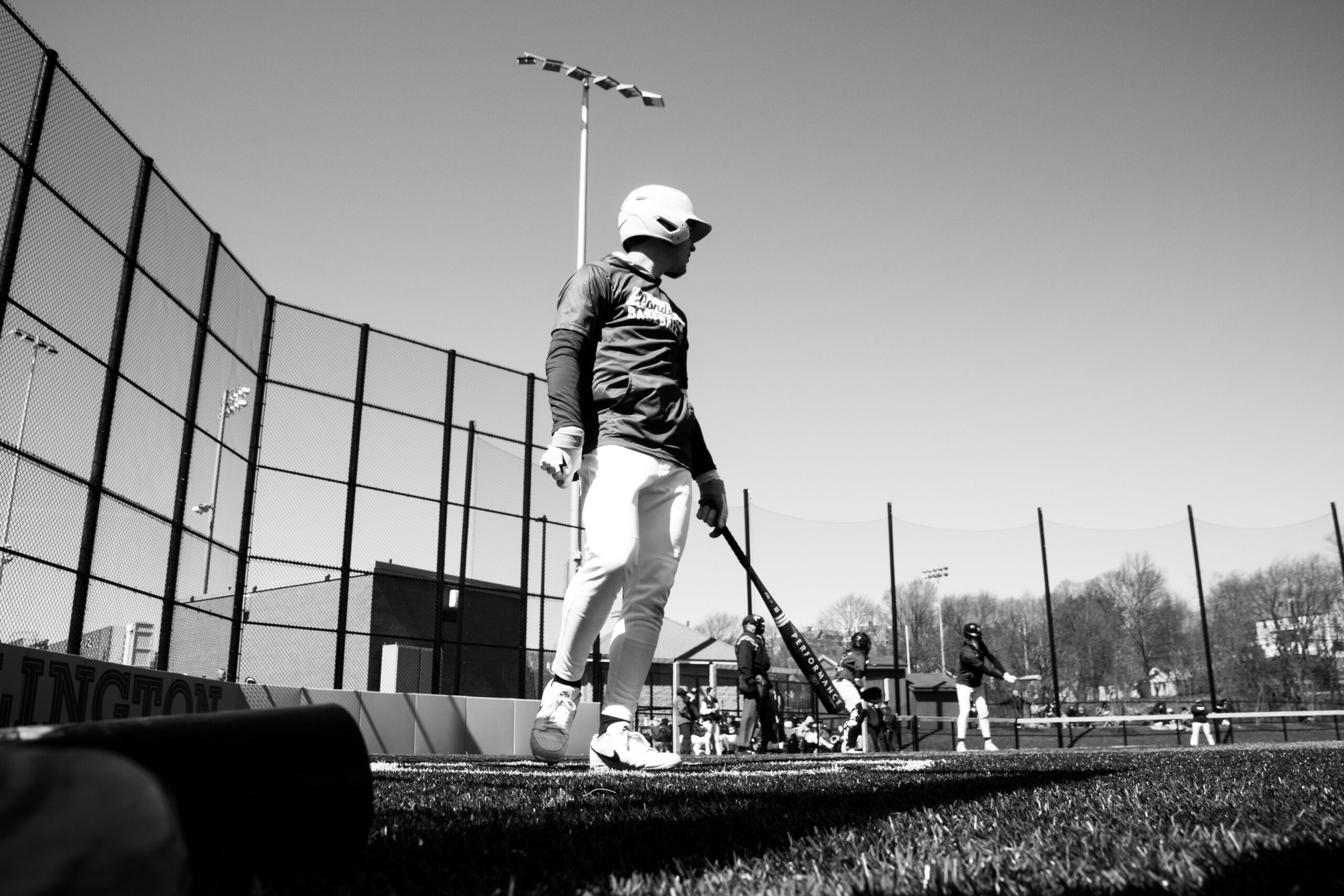A baseball player at home plate, awaiting a pitch.