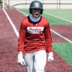 A baseball player yells and clenches his fists in frustration.