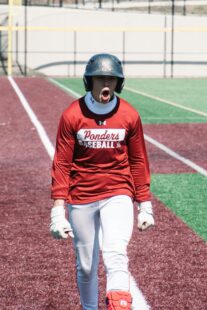 A baseball player yells and clenches his fists in frustration.