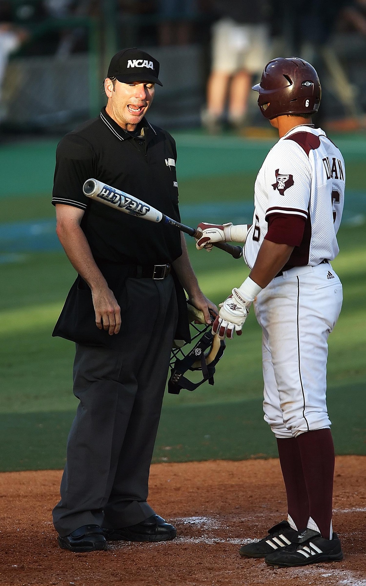 A batter argues with an umpire over a call.