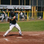 A baseball player at the plate, waiting for the right pitch.
