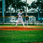 A baseball pitcher stands on the mound, considering the next pitch.