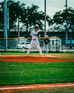 A baseball pitcher stands on the mound, considering the next pitch.
