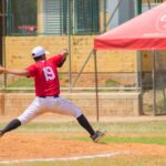 A baseball pitcher is on the mound, ready to release the ball.