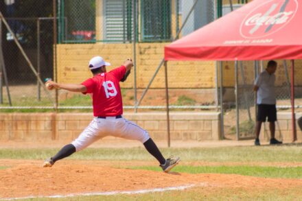 A baseball pitcher is on the mound, ready to release the ball.