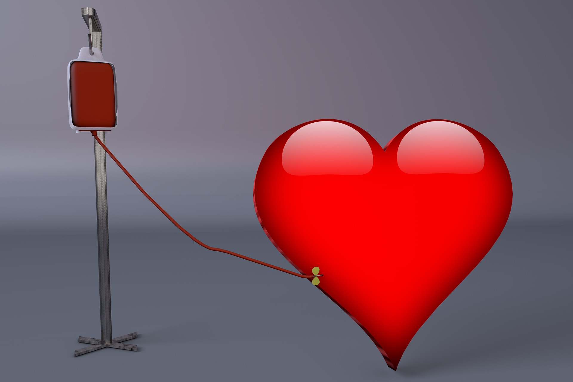 Red heart connected to a blood donation bag and IV stand by a tube, symbolizing blood donation and lifesaving care.