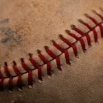 A used baseball with smudges of dirt on it.