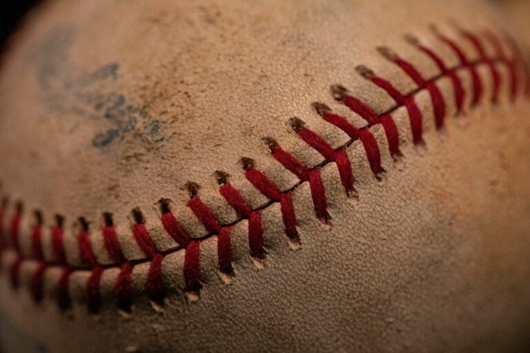 A used baseball with smudges of dirt on it.