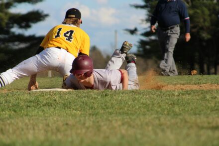 A baseball player attempts to tag out a player who just slid into the base.