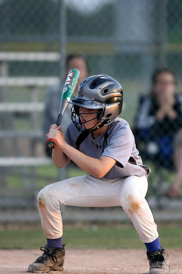 A batter crouches down in readiness.