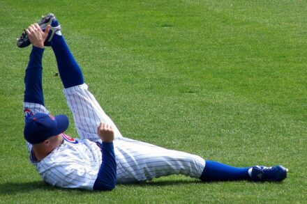 A player for the Chicago Cubs stretches on the field.