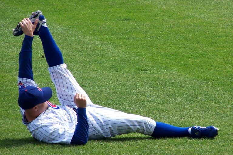 A player for the Chicago Cubs stretches on the field.