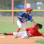 Two baseball players collide at base.
