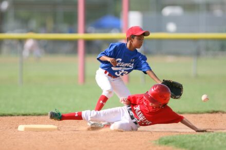 Two baseball players collide at base.