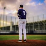 A pitcher stands alone on the mound.