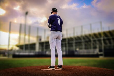A pitcher stands alone on the mound.