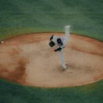 A pitcher takes the mound, ready for the baseball game.