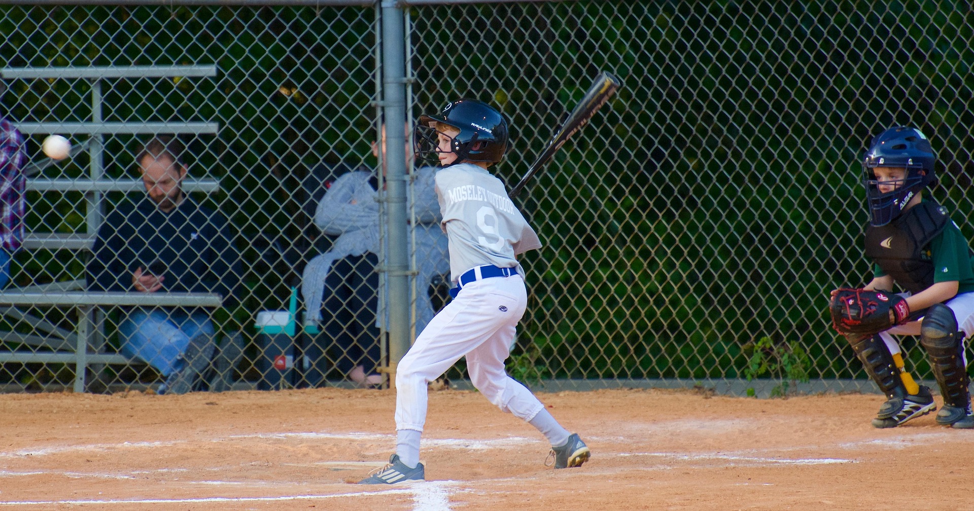 A batter is at the plate, ready for the pitch.
