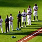 The Astros line up on the field, standing at attention.