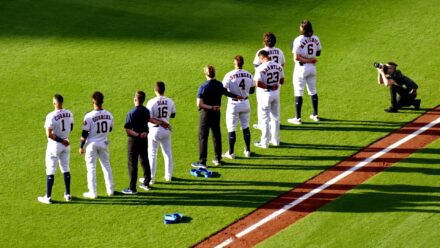 The Astros line up on the field, standing at attention.
