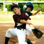 Two baseball players and the ball collide on base.