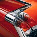 Taillights of a classic car with red fins.