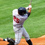 A batter swings away at home plate.