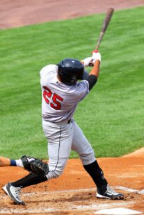A batter swings away at home plate.