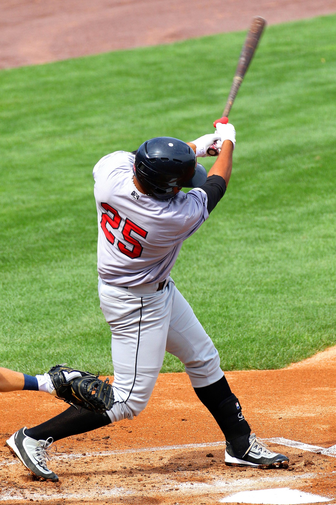 A batter swings away at home plate.