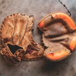 Baseball gloves lying on the ground.