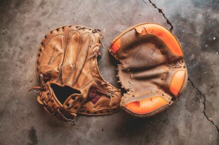 Baseball gloves lying on the ground.